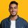 smiling-middle-eastern-man-in-casual-with-laptop-Y9EY47V-500x500